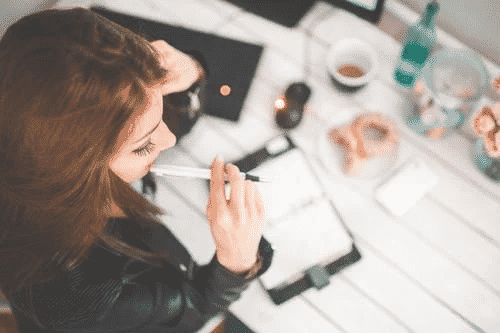 Woman sitting at a desk thinking