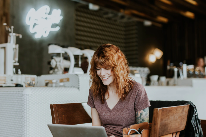 Woman working on laptop in cafe