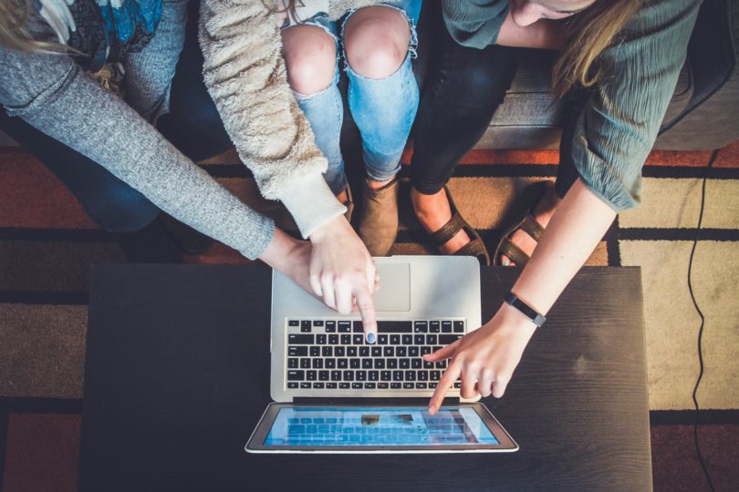 woman pointing at laptop online meeting