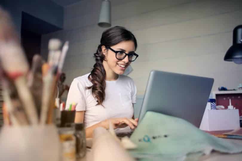 woman with glasses on the computer