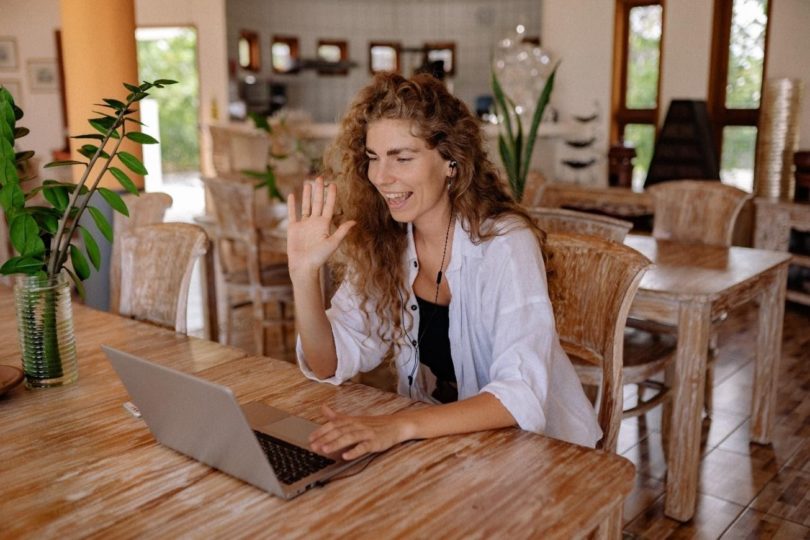 Woman greeting online meeting